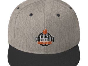BBQ Sidekick grijze en zwarte snapback cap met logo ontwerp voor barbecue en outdoor keuken enthousiasten.