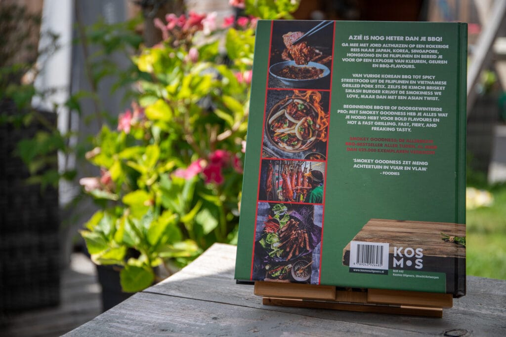 Smokey Goodness BBQ kookboek op houten tafel met tuin op achtergrond